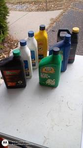 lot 35 image: Assorted Motor Oil and Automotive Fluid Bottles Collection