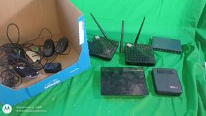 lot 129 image: Lot of Networking Electronics Including Routers, Switch, Data Transfer Hub, Computer Mice and Cables