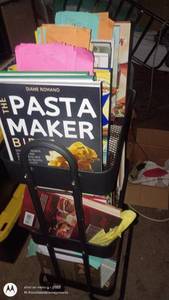 lot 214 image: Rolling Metal Book Rack with Assorted Cookbooks and Magazines