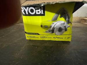 lot 14 image: Ryobi 4 Inch Hand Held Tile Saw with Accessories