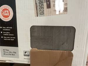 lot 52 image: Lot of 9 Boxes TrafficMaster Grey Wood Parquet Peel and Stick 12x12 Tiles