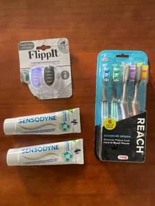 lot 330 image: Dental Care Set with Sensodyne Toothpaste, Reach Toothbrushes, and FlippIt Covers