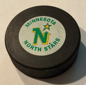 lot 77 image: Minnesota North Stars Vintage Hockey Puck