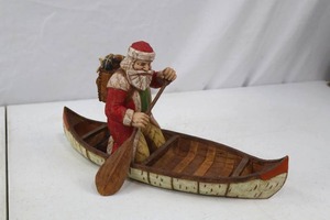 lot 145 image: Hand-carved Santa Claus in Canoe Figurine