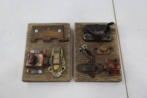 lot 239 image: Lot of Vintage Metal Latches and Catches Mounted on Wood