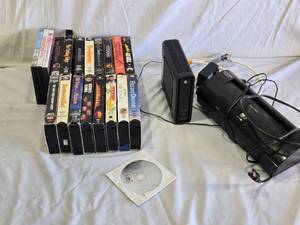 lot 96 image: Lot of VHS Tapes, Arris Modem, and Aurora Shredder