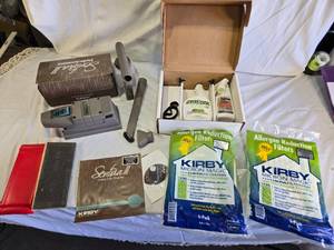 lot 97 image: Kirby Vacuum Accessories and Supplies including Sentria II Attachment, Shampoo, and Allergen Reduction Filters