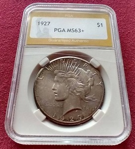 lot 45 image: 1927 Peace Dollar - PGA MS63 Rare Date