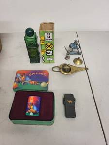 lot 38J image: Eclectic Collectibles Lot Camel Lighter, Avon StopNGo Bottle, Metal Figurines, Brass Lamp & More