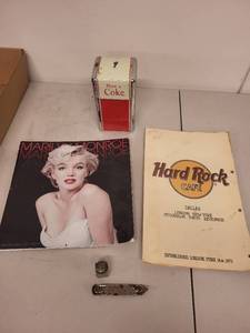 lot 42J image: Vintage Collectibles Lot with 1992 Coca-Cola Napkin Dispenser, Marilyn Monroe Calendar, Hard Rock Cafe Menu, and More