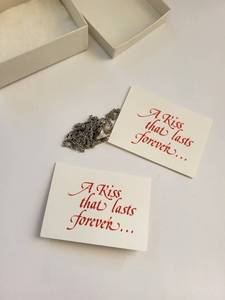 lot 118W image: Pair of Sterling Silver Hersheys Kiss Pendant Necklaces