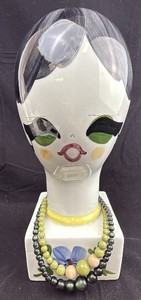 lot 13 image: Ceramic Art Head Italian Bust With Beaded Necklaces & Hand-Painted Floral Base Estimated Replacement Value $400