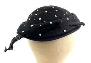 lot 132 image: Merrimac Hat Corp Black Wool Felt Pillbox Hat with Studs & Feather