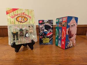 lot 89 image: Vintage Wallace & Gromit Bundle 3 VHS Tapes and Collectible Figure Set