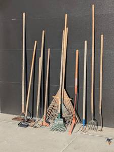 lot 310 image: Assorted Garden Tools Lot with Rakes, Hoes, and Pitchforks