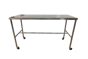 lot 87 image: Sturdy Shampaine Stainless Steel Commercial Work Table  built to last with full stainless steel construction, swivel casters for easy mobility, and a horizontal H-brace for stability. Perfect for kitchens, labs, or surgical prep areas
