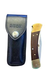 lot 272 image: Buck 110 Folding Knife with North American Hunting Club Etching and Leather Sheath