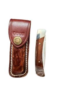 lot 299 image: Buck 501 Folding Pocket Knife with Wooden Handle and Leather Sheath
