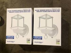 lot 28 image: Lot of LED Clear Glass Porch Lantern with Dusk to Dawn Sensor in White Customer Returns See Pictures