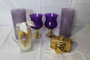 lot 41 image: Decor Collection with Purple Glass Vases, Candles, and Gold Camera Decor