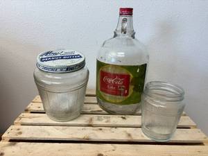 lot 56 image: Now Peanut Butter Large Jar with Lid, Smaller Now PB No Lid and 1 Gallon Coca-Cola Syrup Jug w Original Label
