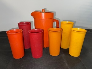 lot 48 image: Vintage Tupperware Orange Pitcher with 6 Tumblers Assorted Colors