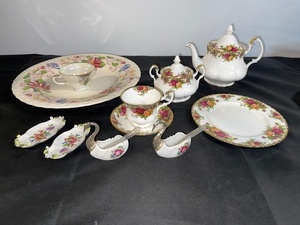 lot 56 image: Vintage Floral Porcelain Tea Set with Plates, Cups, Teapot, and Swan Dishes