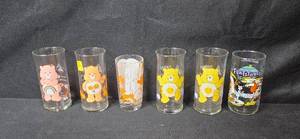 lot 90 image: Set of Vintage Cartoon Character Collector Glasses Care Bears and Flintstones