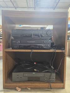 lot 234 image: Lot of 3 VCR Players with Cords, Headphones, and Wooden Stand