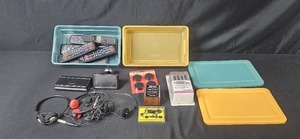 lot 303 image: Electronics Accessory Lot with Remotes, Garmin Nuvi, Headphones, and Cables