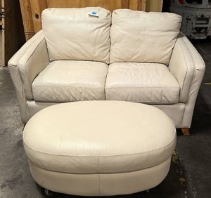 lot 81 image: White leather loveseat with ottomon