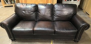 lot 83 image: Dark leather sofa