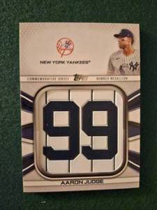 lot 144 image: 2022 Topps Commemorative Player Jersey Number Medallion baseball card featuring Aaron Judge of the New York Yankees.