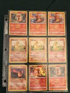 lot 149 image: Collection of 9 various Charmander Pokmon Trading Card Game cards displayed in a binder.
