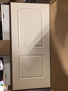 lot 40 image: CALHOME 36 in. x 80 in. White Primed Composite MDF 2Panel Camber Top Sliding Door customer return see pictures