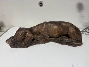 lot 8 image: Large Sleeping Dog Sculpture