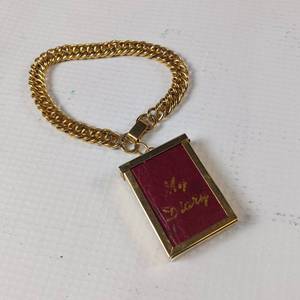 lot 69 image: 1954 Midget Diary on a chain.