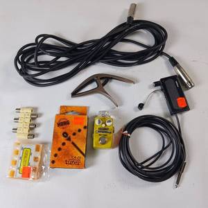lot 127 image: Large lot of music related items  tuners, sound pickup, capo, compact opt compressor