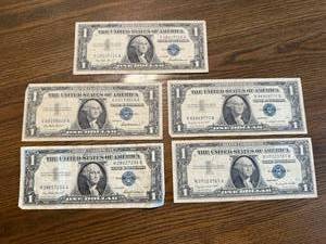 lot 43 image: 5 1957 $1 Blue Seal Silver Certificates