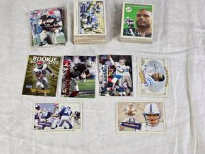 lot 127 image: Large Lot of 1999-2001 Football Cards Featuring Players Like Peyton Manning, Marvin Harrison, and Troy Aikman. Includes Rookie Sensations, Unsung Heroes, and Fleer Tradition.