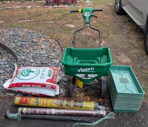 lot 116 image: G - Assorted Yard Care Lot Top Soil, Weed Block, Vigoro Spreader, and Plant Trays