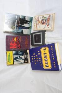 lot 143 image: Lot of Vintage Books, VHS, and 8-Track Tape - Music and Movie Nostalgia