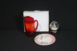 lot 181 image: Group of 3 Collectibles - Red Art Glass Pitcher, Pink Floral Plate, Christmas Snow Globe