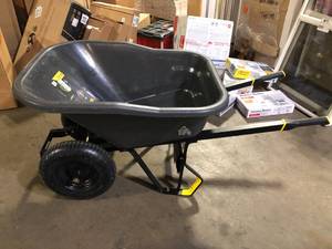 lot 65 image: Gorilla 8 cu. ft. Dual-Wheel Wheelbarrow, Pro-Grade Poly Bucket, Steel Handles, Dual 16 in. Pneumatic Wheels, Easy-Dump Design used customer return see pictures