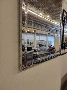 lot 66 image: A Silver Framed Beveled Mirror with Rivet Accents.