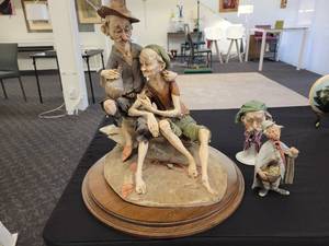 lot 109 image: Vintage Giuseppe Armani Capodimonte Figurine. Men on Beach Rock with Wine & Pipe.