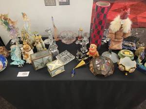 lot 143 image: A table full of Figurines, Dolls, Glassware, Leaded Glass Sconce Cover, China, Perfumes etc.