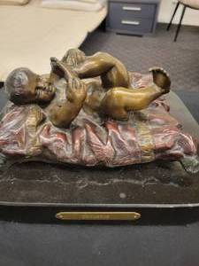 lot 159 image: A Bronze Statue Baby On A Pillow by Chiparrus. 10 x 9 x 6 tall.