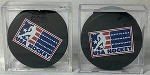lot 168 image: USA Hockey Black Pucks Autographed by Alana Blahok #18 and Karen Bye #6