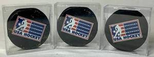 lot 169 image: Bundle of 3 USA Hockey Black Pucks Autographed by Alana Blahok #18 and Karen Bye #6